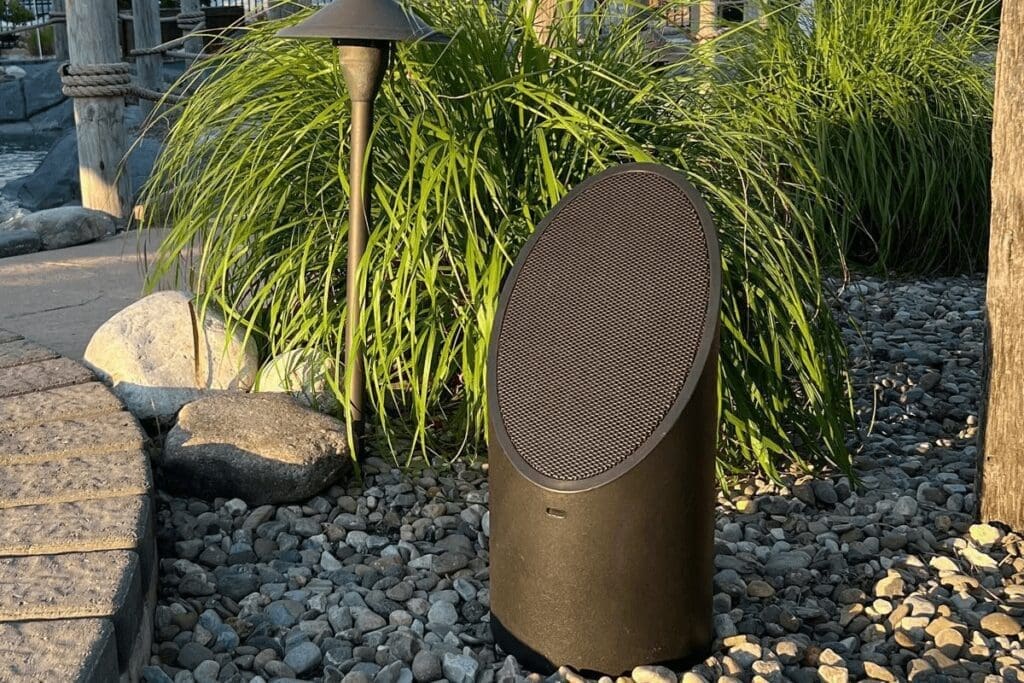 outdoor audio system sitting on house landscaping