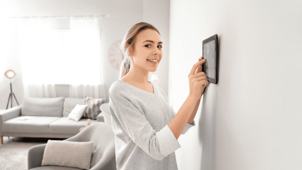 woman using her wall mounted controls for her audio system
