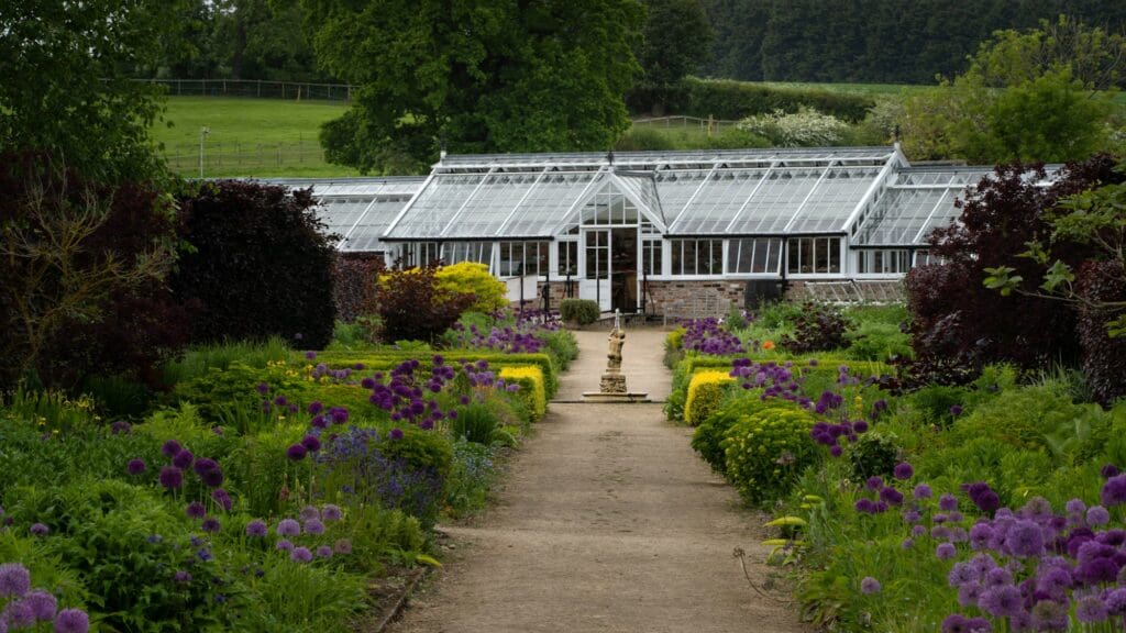 Large glass greenhouse in formal garden