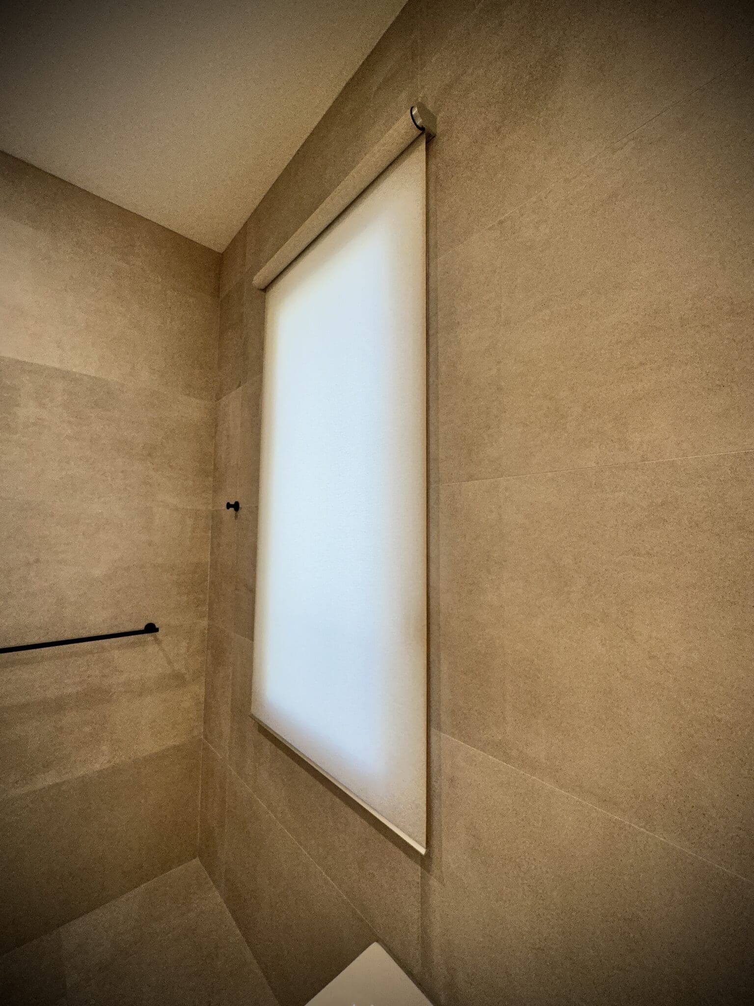 Motorized shade in a tiled shower room in Cambridge, MA