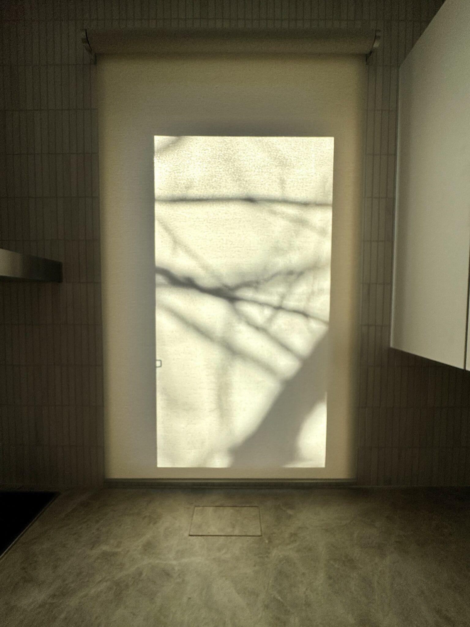 Motorized shade filtering sunlight in a modern Cambridge, MA bathroom