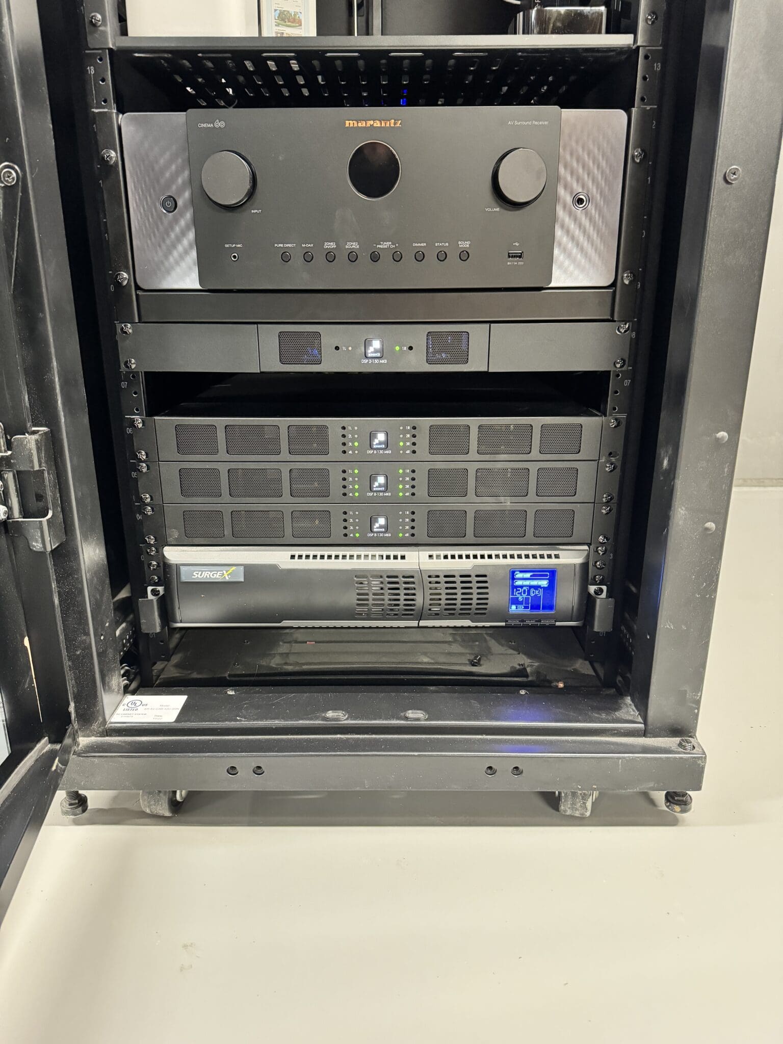 Equipment rack with a Marantz Cinema 60 receiver and Sonance amplifiers
