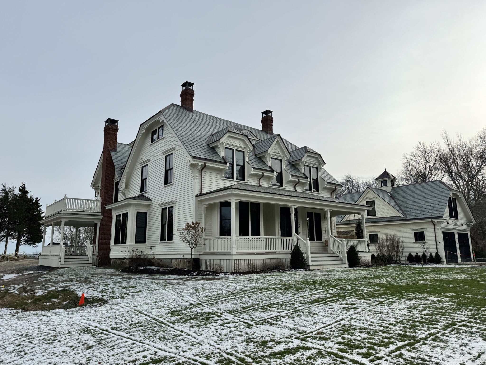 Shingled Queen Anne house with a wraparound porch at Manomet Point, Plymouth, MA
