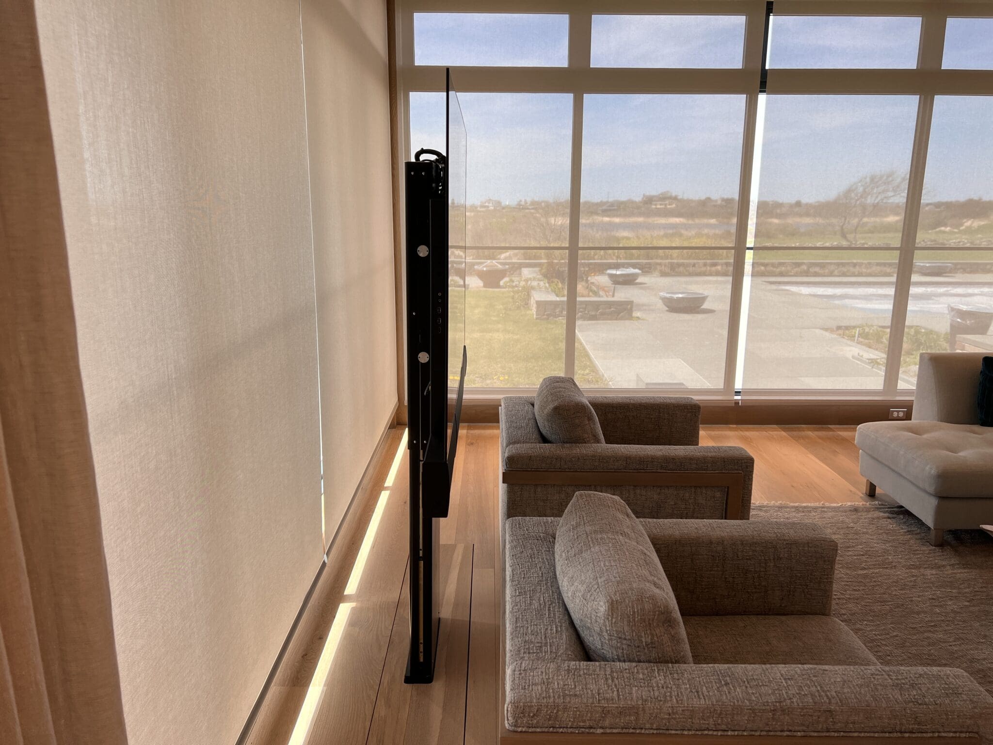 Lutron shades and a TV lift in a Little Compton, RI living room