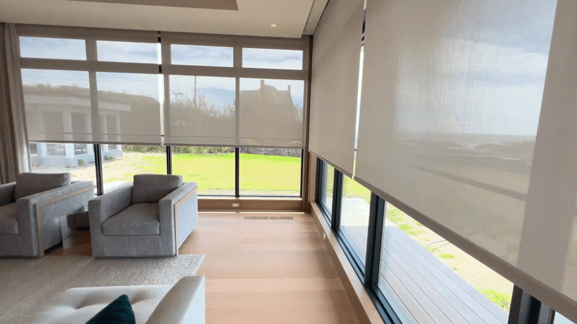 Lutron shades lowered across a wall of windows in Little Compton, RI