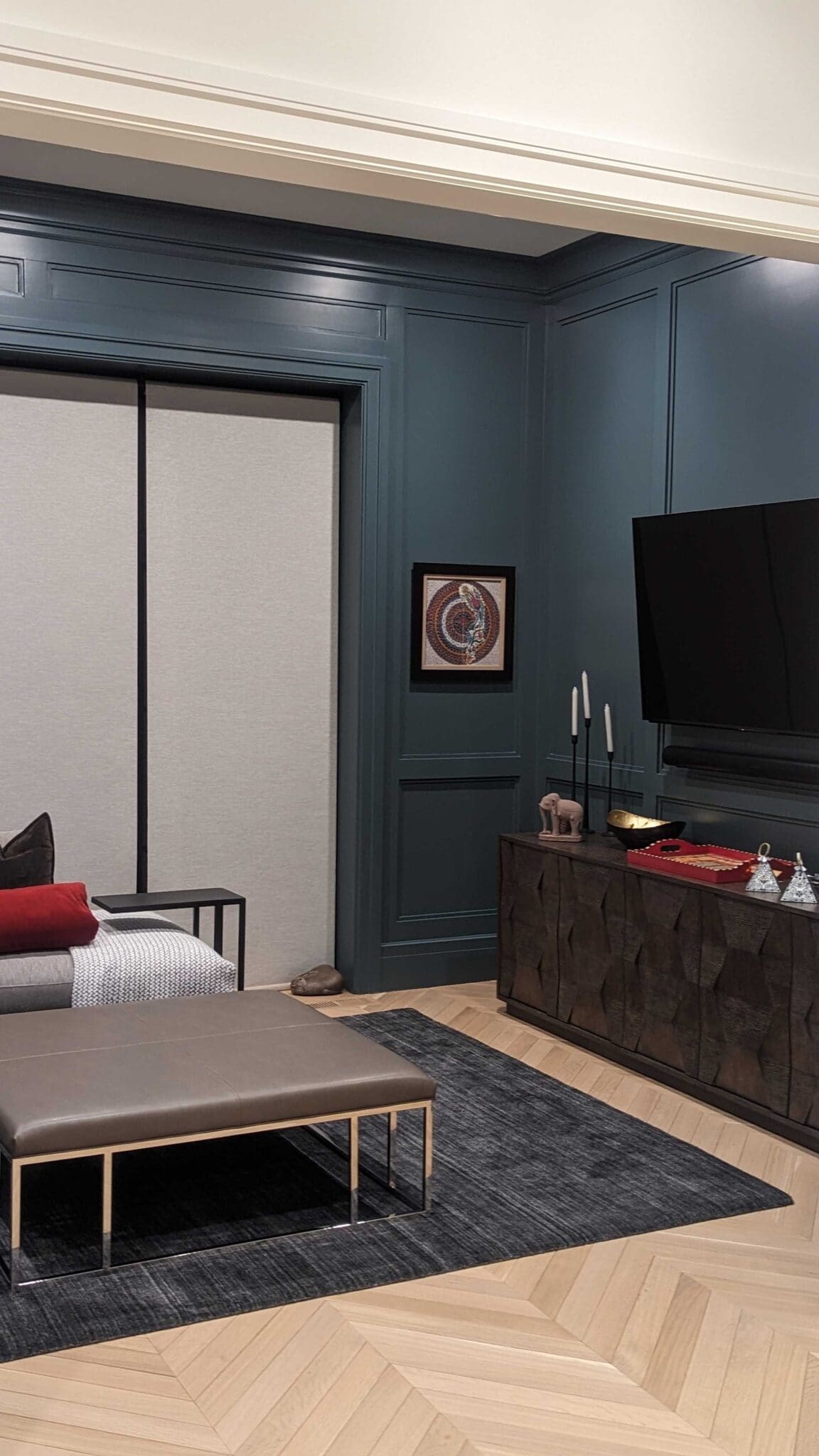 Living room with lowered Lutron shades and TV in Boston