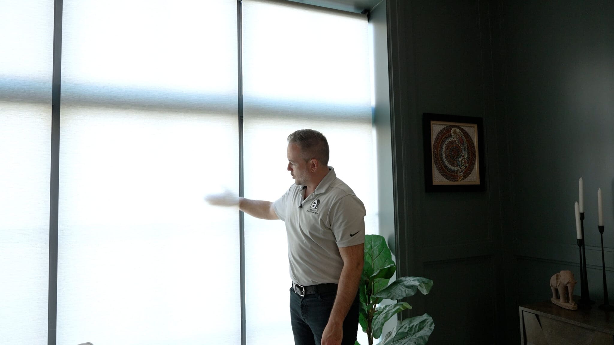 Adam Zell showing a Lutron shade in a South End, Boston living room