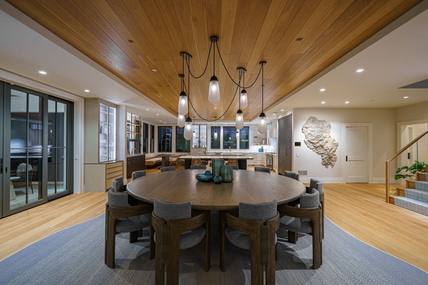 Dining room with cedar ceiling, cluster pendant lighting and automated shades