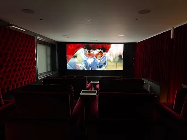 Home cinema with motorized blackout velvet drapery closed for a movie
